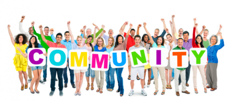 Group of people holding sign saying Community